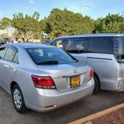 Two packed airport transfer vehicles ready for passenger pickup from Karen to JKIA Airport