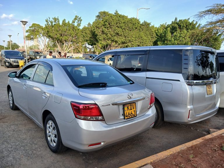 Two packed airport transfer vehicles ready for passenger pickup from Karen to JKIA Airport