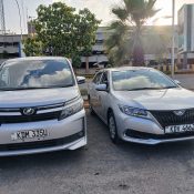 Two packed airport transfer vehicles ready for passenger pickup in Nairobi