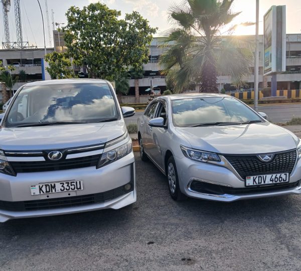 Two packed airport transfer vehicles ready for passenger pickup in Nairobi