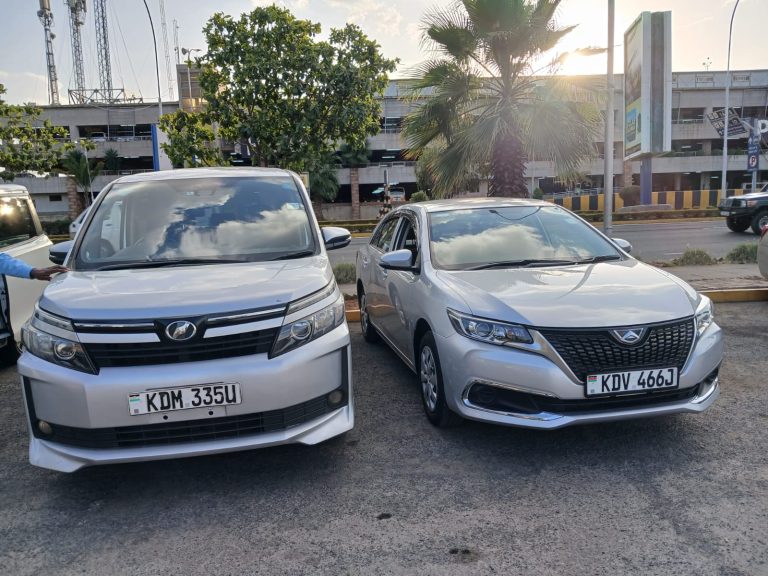 Two packed airport transfer vehicles ready for passenger pickup in Nairobi